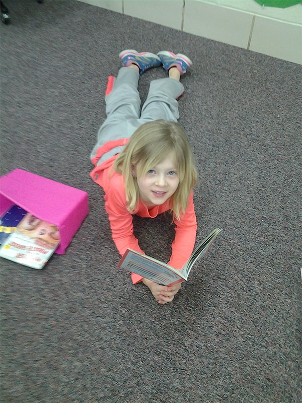 A first grade student at Lakeview Elementary School reads during I Love To Read month in February. — Provided