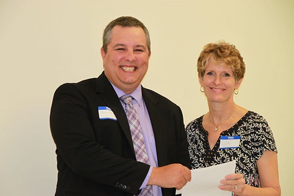 Jason Howland of Albert Lea Community Theatre, Inc. accepts a grant on the organization‘s behalf from Jillian Peterson, board chairwoman of the Freeborn County Community Foundation. - Provided