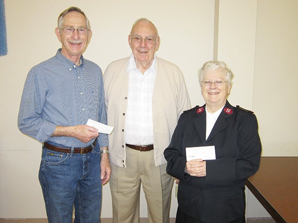 Orville Simonsen, representing the Ecumencial Food Pantry, center, and Maj. Elsie Kline of the Salvation Army food shelf, right, are presented checks from Bill Webster of Western Star Lodge, left. Western Star Lodge presented  $500 checks to each food shelf. They applied for matching funds from the Grand Lodge of Minnesota that will be presented at a later date once received. -Provided