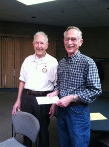 Earl (Jake) Jacobsen presented Orv Simonson a check totaling $1235 from Albert Lea Rotary for the Ecumenical Food Shelf. Provided