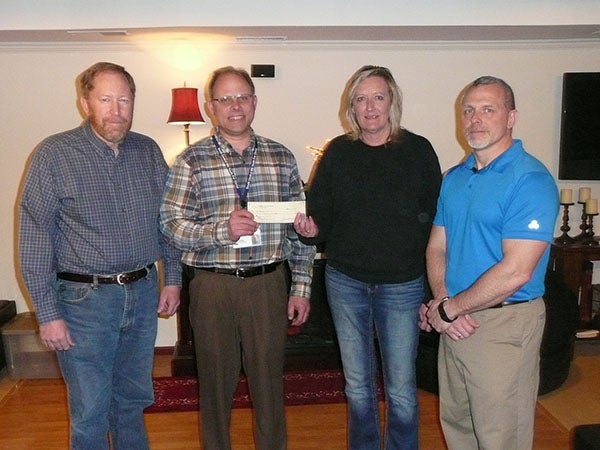Grant Lohse and Patty Grove from Ruby’s Pantry Benevolence Committee present a check for $500 to Greg Gudal and Rick Miller from Youth For Christ. Pictured above, from left are Grant Lohse, Greg Gudal, Patty Grove and Rick Miller. -Provided