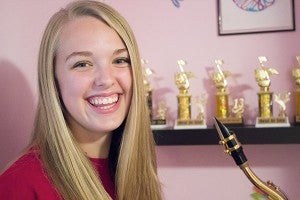 Grace Chalmers stands in front of a shelf in her bedroom with her Best in Site awards from solo/ensemble contests. She has won seven awards since fifth grade, four of which were this year. -Hannah Dillon/Albert Lea Tribune