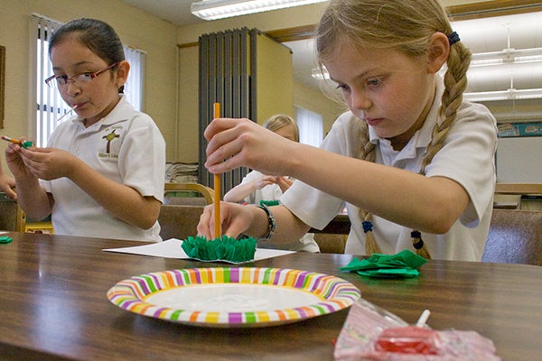 Second-grader Emma Vogt diligently works on a craft project of the Mexican flag in May 2011 at St. Theodore Catholic School. The students got to make a special project as part of Cinco de Mayo. - Sarah Stultz/Albert Lea Tribune