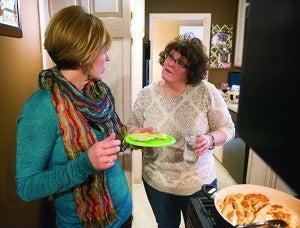 Julie Nafzger, left, and Ann Howe talk while finishing up in the kitchen during a Japenese-themed moai. - Colleen Harrison/Albert Lea Tribune