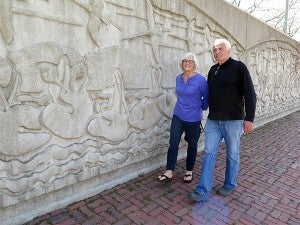 A 300-feet-long concrete floodwall in downtown Winona that protects the city from rising Mississippi river water was made in the mid-1980s from a wood sculpture by artist Leo Smith, who walked along the river wall with his wife, Marilyn, on April 17. — Dan Olson/MPR News