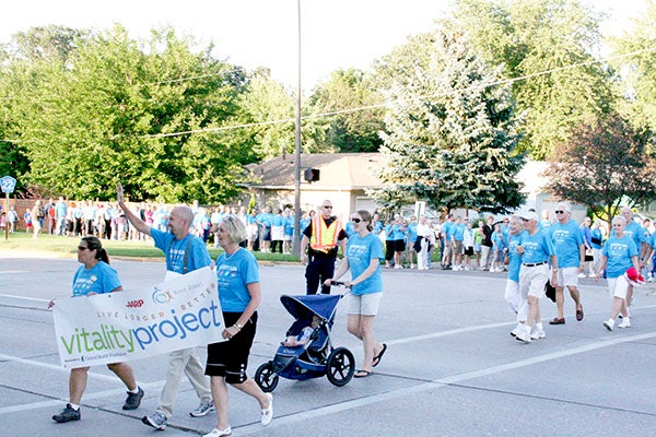 Participants in the 2009 walking moais cross the intersection of Bridge Avenue and Richway Drive at the start of the moai celebration in August 2009. Summer walking moais will kick off again on Saturday morning at Fountain Lake Park. - Tribune file photo