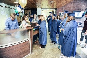 Riverland students check in prior before commencement execises Friday at Frank W. Bridges Theatre at Riverland Community College. — Eric Johnson/Albert Lea Tribune