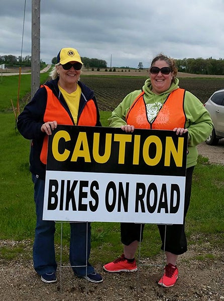 The Albert Lea Lions Club helped with traffic control on the biking leg of the race during the Land Between the Lakes Duathlon on Sunday. Pictured are Albert Lea Lions Irene Anderson and Tammy Krowiorz at the corner of Bath Road and Lerdal Road. The Lions stopped and slowed down traffic at all the corners on the bike route, helping to keep the bikers safe. -Provided