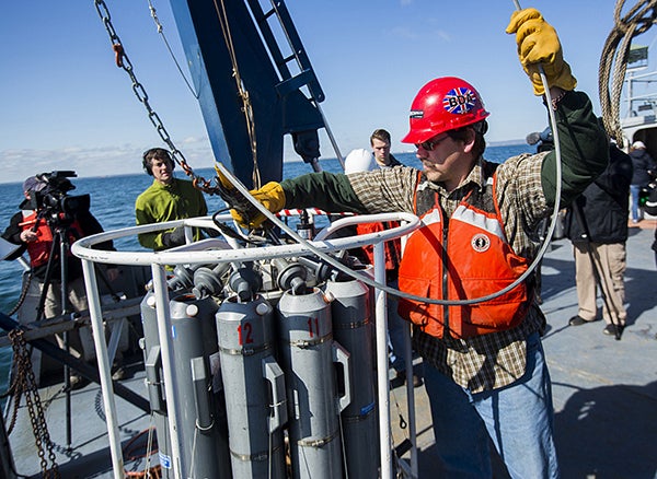Marine technician Jason Agnich prepares to deploy the rosette, which collects water at specific depths, aboard the Blue Heron on Lake Superior near Duluth. - Derek Montgomery/ Courtesy of University of Minnesota