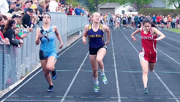 Lexi Groe of Lake Mills, middle, qualified for the Class 2A state track meet with a third-place finish in the 400-meter hurdles with a time of 1:08.46 Friday at the district meet at Osage. — Lory Groe/For the Albert Lea Tribune