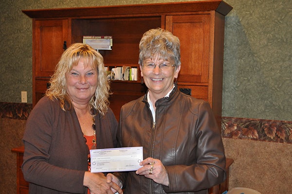 Deb Hanson from the Worth County Development Authority presents a check to Pat Mulso from the Freeborn County Historical Museum. The grant of $3,882 allowed the museum to purchase a new copy machine. -Provided