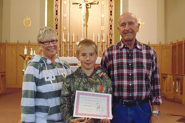 St. Casimir’s Catholic School of Wells congratulates Caldyn Huper, son of Eric and Kayla Huper and the late Melissa Huper, for being chosen as this year’s winner of the Ben Bushlack Scholarship for the coming school year. Huper was chosen on the basis of his kind and generous character and his willingness to always go the extra mile to help out and do his best. Huper is pictured with Bushlack’s parents MaryBeth and Gary Bushlack. - Provided