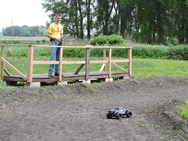 Robert Weigel, employee at the Hayward KOA Kampground, manuevers one of the remote-controlled vehicles the camp offers for rent through the newly-designed race track. - Kelly Wassenberg/Albert Lea Tribune