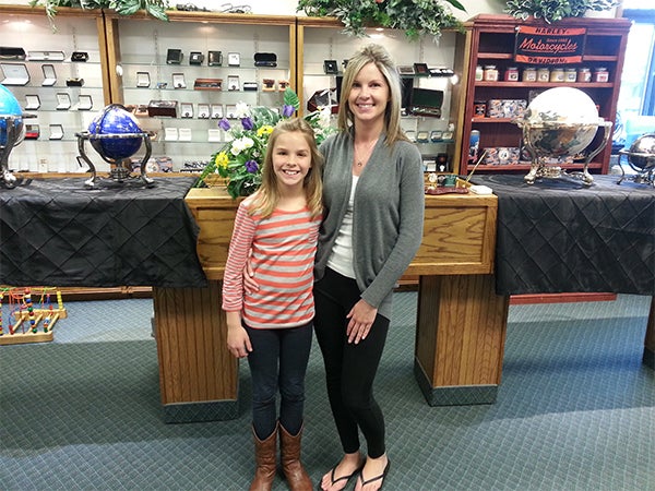 Leah and Katelyn Lawrence pose in Fisher’s Fine Jewelers while getting the pendants for being one of the winners of the Mothers Day photo contest. — Provided