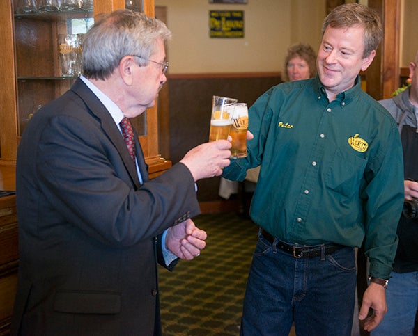 Gov. Terry Branstad and Worth Brewing Co. owner Peter Ausenhus toast the company's expansion plans Friday in Northwood. - Colleen Harrison/Albert Lea Tribune