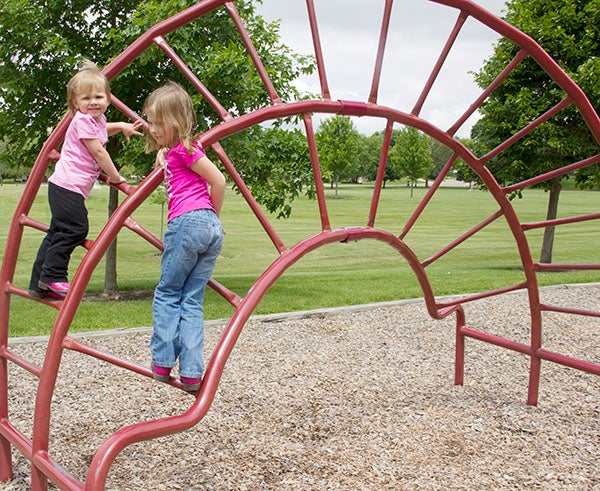 Five-year-old Allie Nelson climbs the jungle gym at Lakeview Park with her sister Josie Nelson, 3, on Friday. Their grandmother, Gale Nelson, took them to the park to get their energy out. - Madeline Funk/Albert Lea Tribune