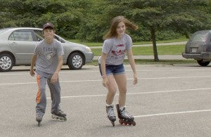 Ally Rassmussen rollerblades the lake with her friend Logan Barr to get their exercise in for the day. - Madeline Funk
