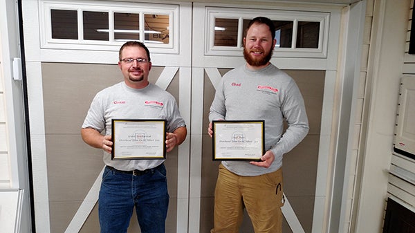 Overhad Door Company of Albert Lea employees Grant Van Ryswyk and Chad Auen receive national certification as certified commercial sectional door system technicians. - Provided