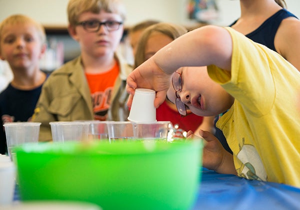 Children make fireworks in a cup with different dyes and oils Tuesday during Science Blast at Albert Lea Public Library.  -Colleen Harrison/Albert Lea Tribune