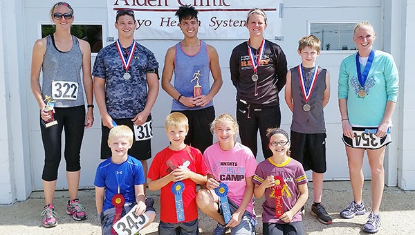 First- and second-place finishers at the Alden Morin Lake Days Fun Run on June 20 stand with medals and ribbons. Front row from left are Parker Hintz, Tyler Erickson, Grace Erickson and Jenna Schmidt. Back row from left are Melissa Wasmoen, Derek Bute, Cody Habana, Melissa Hintz, Aiden Cummings and Jessica Stensrud. Bob Usselman and Sarah Dulitz are not pictured. Results are in the scoreboard. — Provided