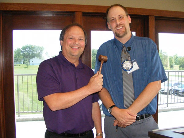 Albert Lea Lions outgoing President Eric Youlden passes the gavel to incoming President Don Schroeder. - Provided