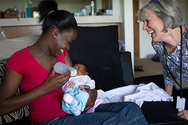 Growing evidence suggests intensive home visits can improve survival rates for African-American and American Indian babies. Here, nurse Deb Avenido worked with new mother Ananka Young and her 2-week-old daughter, Anayah, during a visit to Young's St. Paul home. — Jennifer Simonson/MPR News