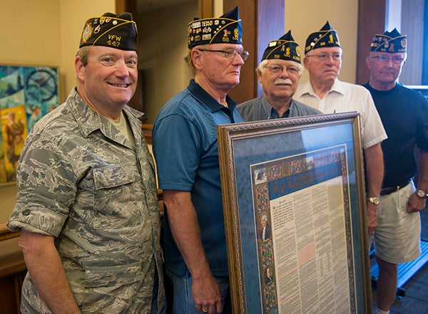 Gary Stephenson presented a 1934 print of the Constitution Tuesday at the Freeborn County Government Center. Area veterans organizations were present for the event. Pictured, from left, are the VFW’s Jim Hockinson and the American Legion’s Wes Halverson, Dave Mullenbach, Bill Goette and Lowell Peterson. - Colleen Harrison/Albert Lea Tribune