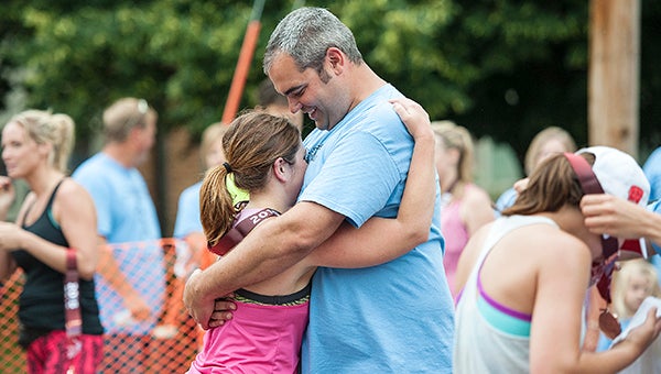 Josh Sorensen, who was April Sorensen's husband, hugs Anna Skov, a participant in the April Sorensen Half Marathon, after she crossed the finish line and was awarded a medal Saturday in Hayward. — Micah Bader/Albert Lea Tribune