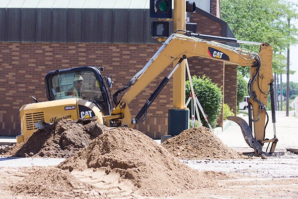 A construction worker digs into the ground on Friday on South Broadway near U.S. Bank. - Elena Schewe/Albert Lea Tribune