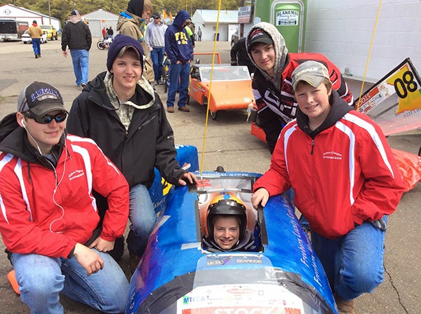 Supermileage members, from left, Strauss Langrud, Grayden Thompson, Riley Petersen and Jacob Helland pose with the driver of the stock car, Jacob Songstad. - Provided