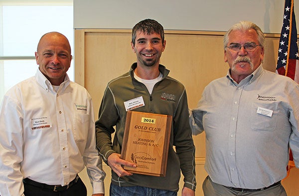 Steve Smith, left, and Jim Cusack, far right, present Mark Johnson of Johnson Heating and Air Conditioning with the Gold Club Award during their annual Enertech Global Dealer Meeting. - Provided