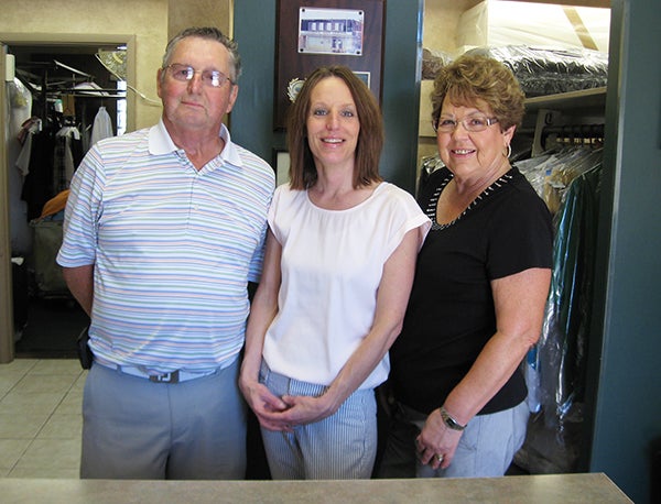 Robin Carstens, center, and her parents, Russ and Gladys Heys, have been a part of Clothing Care Center since 1986. The Heys purchased the business that year, and Carstens purchased it from her parents in 2008. They will celebrate 30 years of ownership in the family in 2016. - Renee Citsay/Albert Lea Tribune