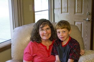 Monica Nelson sits with her son Tanner, who was three at the time of Monica’s cancer. - Madeline Funk/Albert Lea Tribune