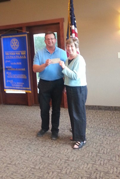 Rotary President Garry Hart presents a $500 check to Lilah Aas for her 500 mile Habit for Humanity bicycle ride, which was July 12 to 18. - Provided