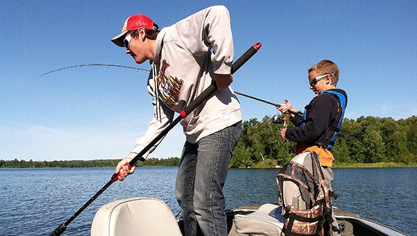 Dylan Herfindahl nets his step-brother Caiden Shure’s first Spider Lake northern. — Dick Herfindahl/Albert Lea Tribune
