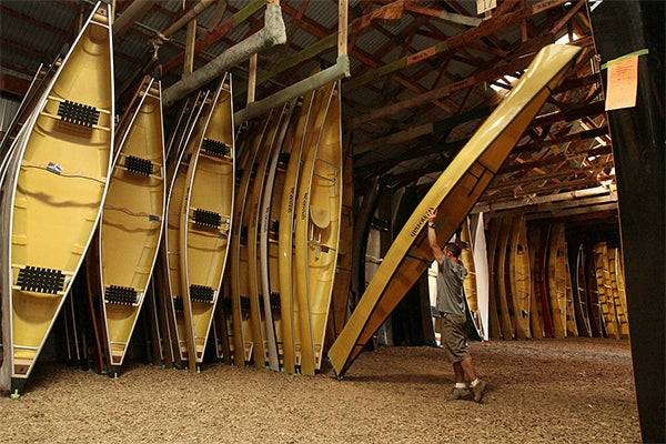 Zak Ambuhl moved canoes around in the storage area of Wenonah Canoe to prepare them for shipping in Winona. Winona, a city of 28,000 residents, is home to Minnesota's largest cluster of composites manufacturing. — Alex Kolyer/For MPR News