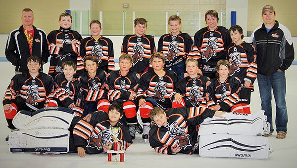 The 2003 Ice Bucks of the AAA Northland Hockey Group, a team with 12-year-old players, pose with the third-place trophy on Aug. 9 at Bielenberg Recreation Center in Woodbury. The Ice Bucks completed their season with a 9-7 overall record. From April 10 to Aug. 9, the team participated in four tournaments and finished in the top for at each. The Ice Bucks took third at the AAA Opener, fourth at the Mountain Dew Blast, third at the NHG Cup and third at the NHG Combat Cup. The team practices at Albert Lea City Arena. Front row from left are Aaron Salazar, Iowa; and True Gieake, Owatonna. Middle row from left are Tate Trullinger, New Ulm; Dylan Schroeder, Wisconsin; Logan Barr, Albert Lea; Blake Ulve, Albert Lea; Logan Hacker, Albert Lea; and Kyler Gronewald, Fairmont. Back row from left are coach J.D. Carlson, Albert Lea; Bryce Purtill, Iowa; Nate Williamson, Rochester; Zach Kruse, Luverne; Isaiah VanRyswyk, Albert Lea; Hayden Jones, Rochester; Michael Gratz, Florida; and coach Chad Hacker, Albert Lea. — Provided