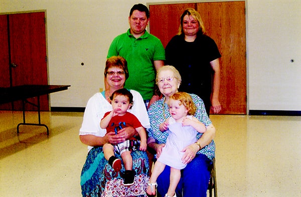 Shown standing are Justin Bronson, father, and Lynae Bergeson, grandmother; sitting are Linda Bergeson, great-grandmother, holding child Landon Bronson, and Harriet Wittmer, great-great-grandmother, holding child Ryleigh Bronson. -Provided