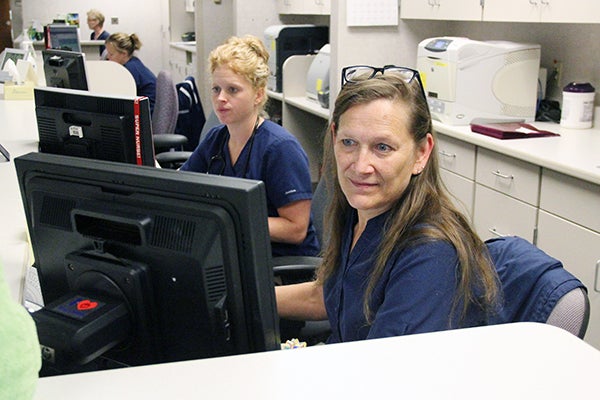 Licensed pratical nurses Denise Benson, front, and Ashley Jacobson work Tuesday at Mayo Clinic Health System in Albert Lea. Jacobson started classes at Riverland Community College on Monday for the college’s Bachelor of Science in nursing program. - Sarah Stultz/Albert Lea Tribune