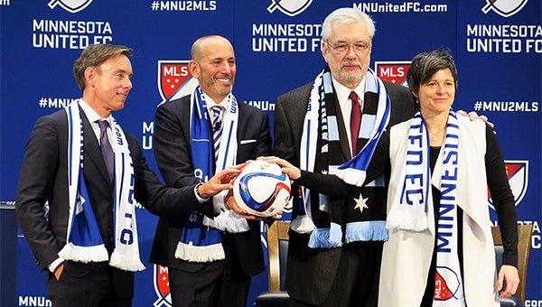 Investors Bob Pohlad, left, Wendy Carlson Nelson, far right, and Bill McGuire join MLS Soccer Commissioner Don Garber at an announcement at Target Field in Minneapolis March 25. -Tim Nelson/MPR News