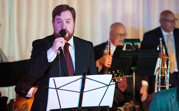 Bradley Carlton sings during a song played by the Austin Big Band, a 17-piece jazz band that features musicians from southern Minnesota and northern Iowa Saturday at the Riverland Community College 75th anniversary gala at Northbridge Mall. Carlton said he has been a member of the band for nine years. - Micah Bader/Albert Lea Tribune