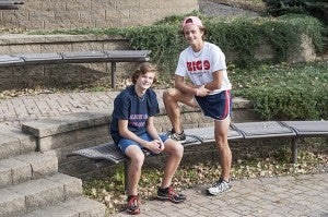 Brothers Carson Goodell, left, a freshman, and Jackson Goodell, a senior, await cross country practice Wednesday at Albert Lea High School. — Micah Bader/Albert Lea Tribune