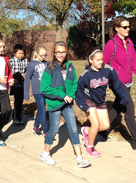 Lakeview Elementary School students walk down the sidewalk near the school Oct. 9 for the annual walkathon. The students raised $21,000. - Provided