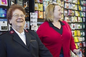 Volunteer bell ringers Elsie Cline and Marilynn Lancaster fundraise for the Salvation Army Friday morning at Hy-Vee. - Sam Wilmes/Albert Lea Tribune