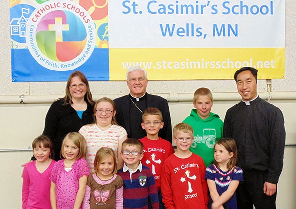 Bishop John Quinn visits St. Casimir’s Catholic School in Wells. Principal Joanne Tibodeau, Tri-Parish Pastor Rev.Andrew Vogel and students of the school welcome him to dine with them. - Provided