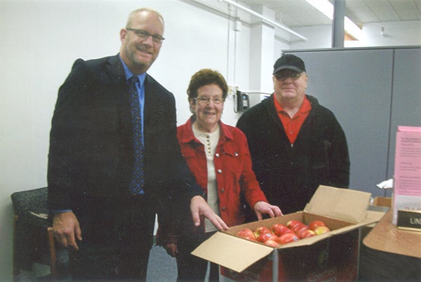 As a part of the United Methodist Church’s Bless the Schools project present, church members present apples donated by Marketplace Foods to Southwest Middle School during American Education Week. Steve Kovach, principal at Southwest, accepted the donation from JoAnn Seuser, representative of United Methodist church, and Lowell Jacobson of Marketplace Foods. Sue Lee of United Methodist is not pictured. - Provided
