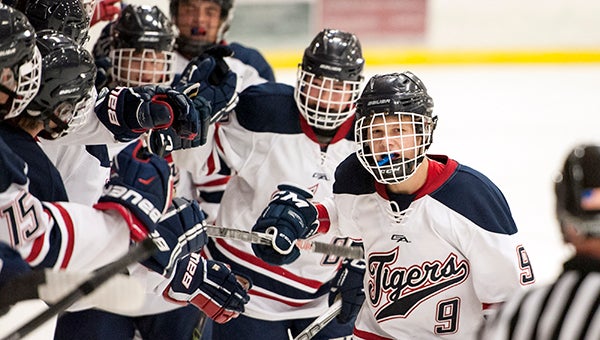 Albert Lea's Jack Pulley leads the Tigers past the bench after one of the team's seven goals was scored Thursday against Mankato East/Loyola at Albert Lea City Arena. — Micah Bader/Albert Lea Tribune