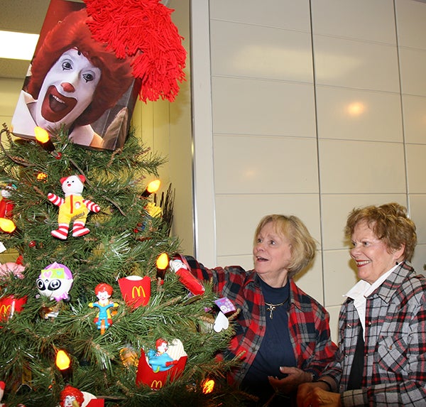 Joyce Nixon and Carol Wolter put the finishing touches on the tree sponsored by McDonald’s for the Albert Lea Art Center Festival of Trees that runs  Sunday through Dec. 23 at Northbridge Mall. A fundraising event, Evening of Dazzle, will be Saturday with food, wine, live music and lighting of the trees. - Cathy Hay/Albert Lea Tribune