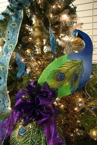 The Grapevine Twist tree and peacock theme on the American Association of University Women tree show how color creates a decorating theme. - Cathy Hay/Albert Lea Tribune