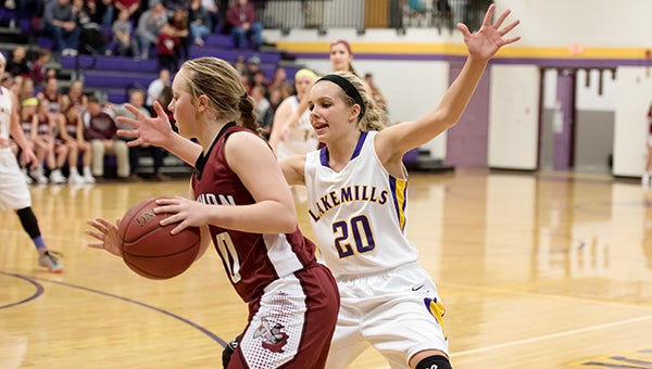Jewell Gasteiger of Lake Mills defends a Newman Catholic ballhandler Tuesday at Lake Mills. — Lory Groe/For the Albert Lea Tribune